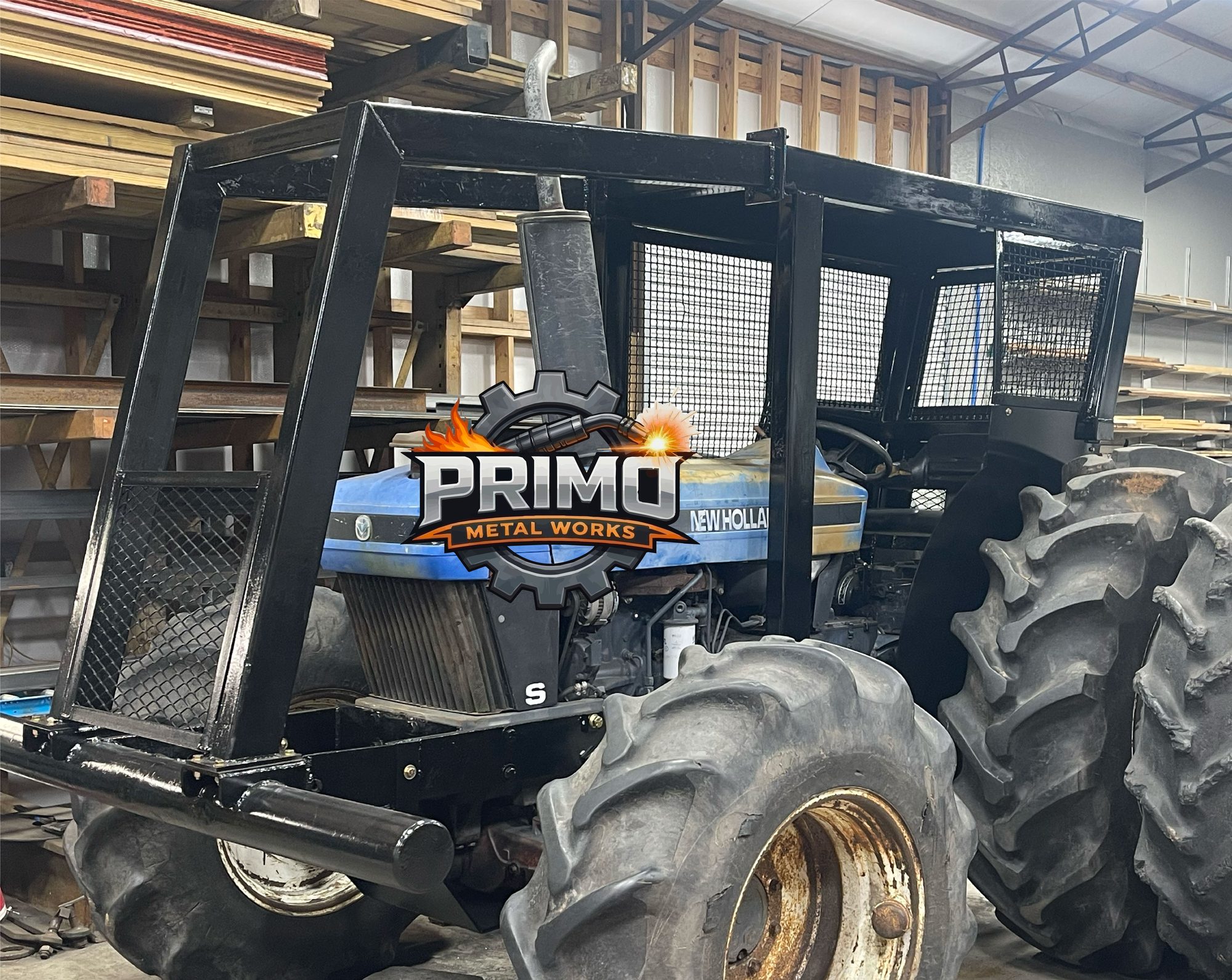 Ornate rectangular tube frame with scrolls, standing in the shop. The Primo Metal Works logo is on the photo
