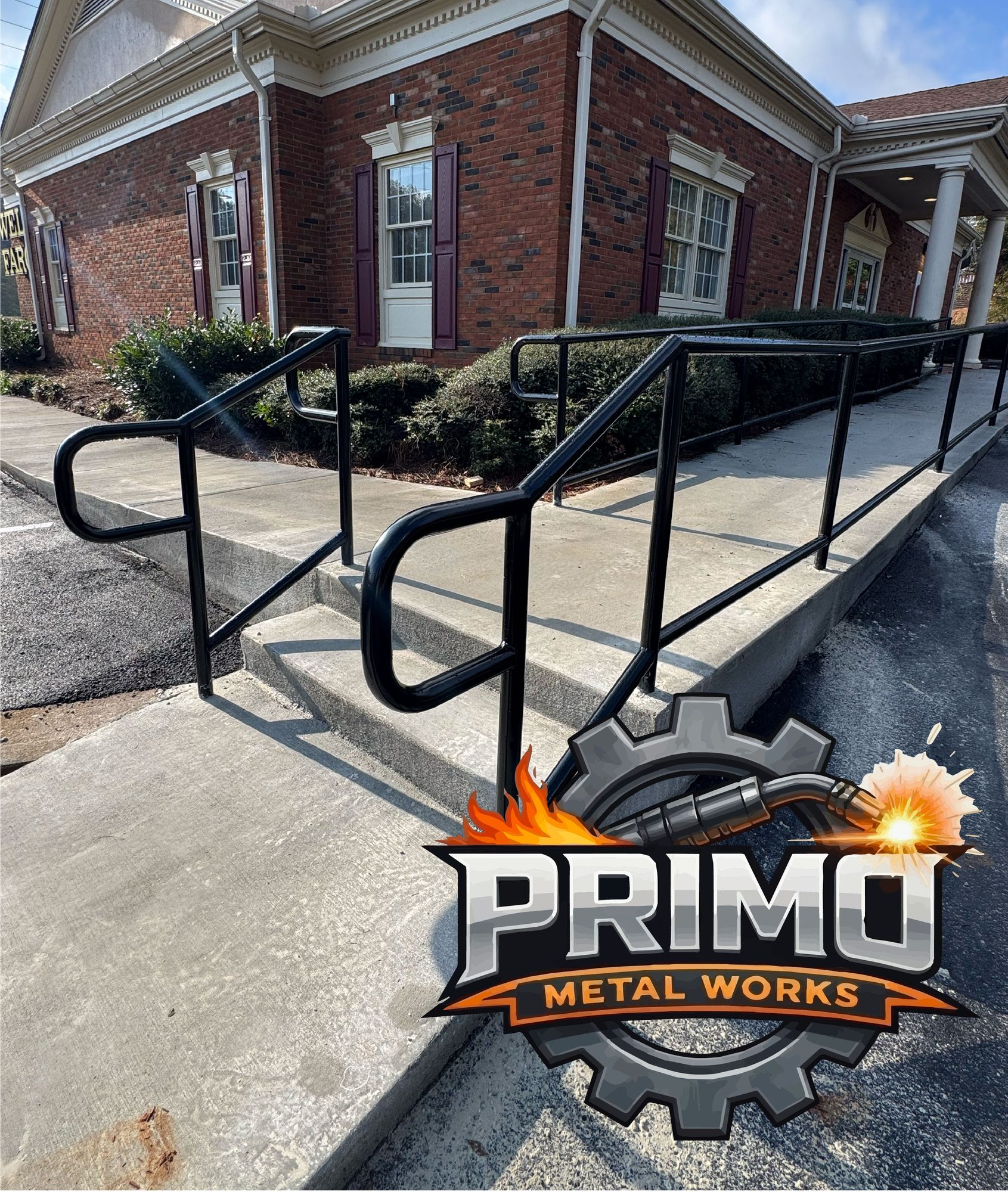 Wall-mounted handrail of round tube on square posts. The Primo logo is in the lower left