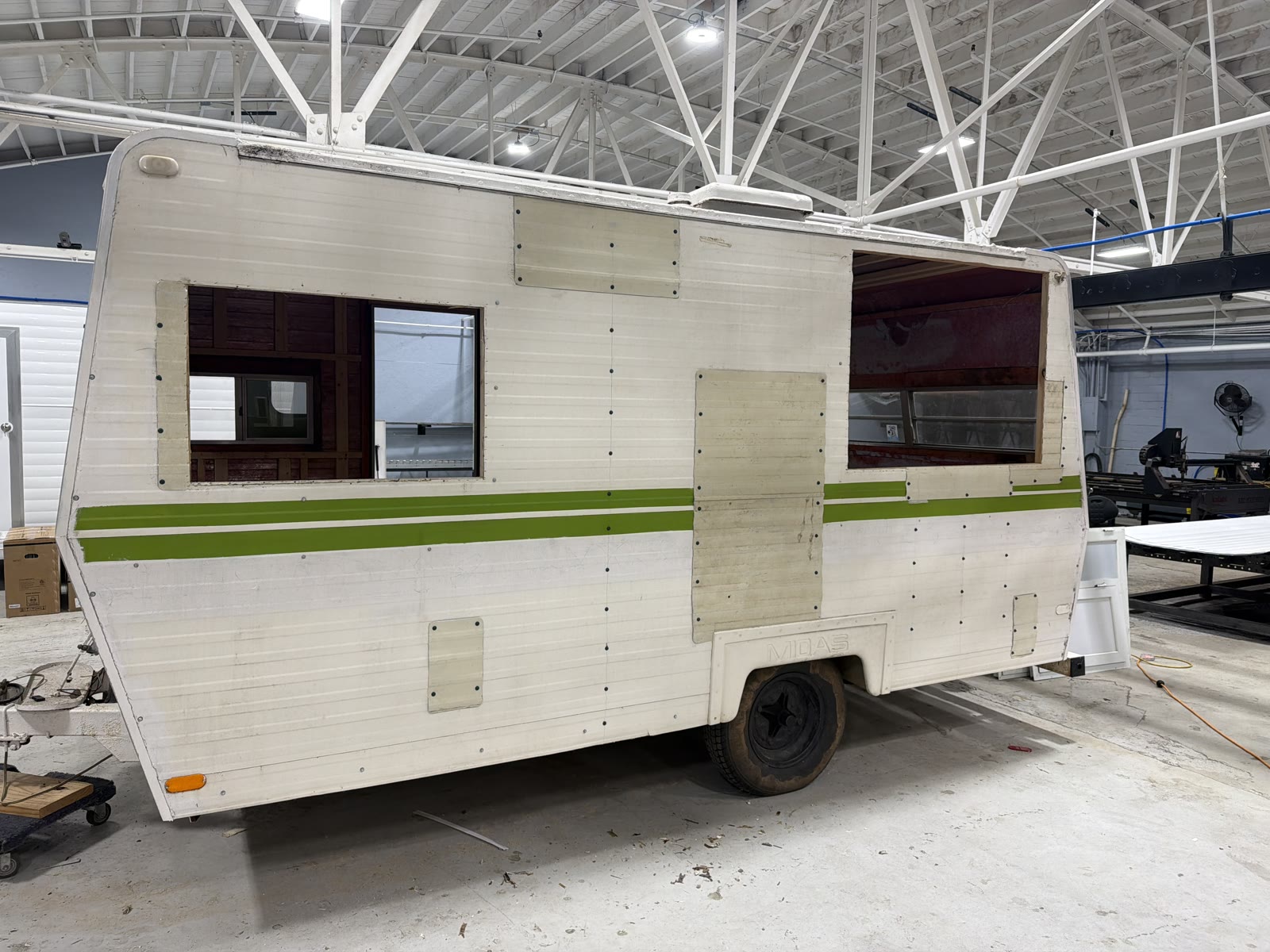 Trailer exterior during a renovation, with openings cut in the shell